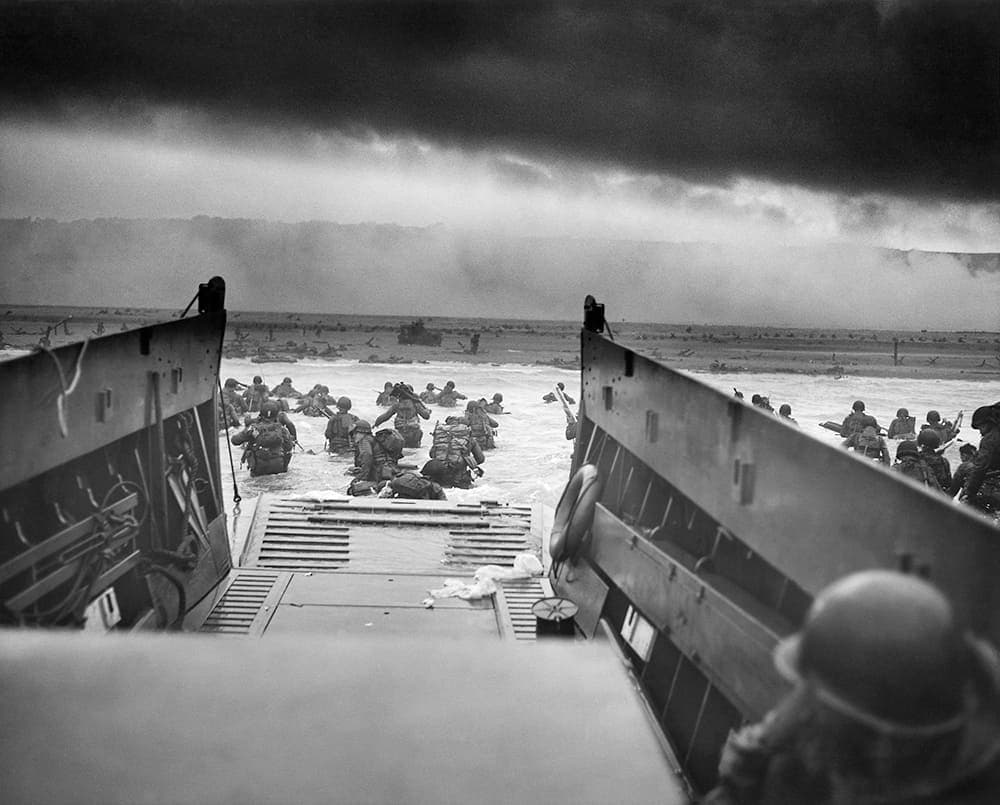 WWII: Europe: France; “Into the Jaws of Death — U.S. Troops wading through water and Nazi gunfire”, circa 1944-06-06.